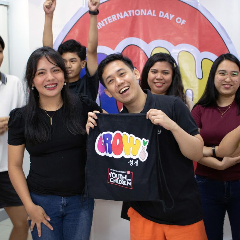 A group of young people smile at the camera