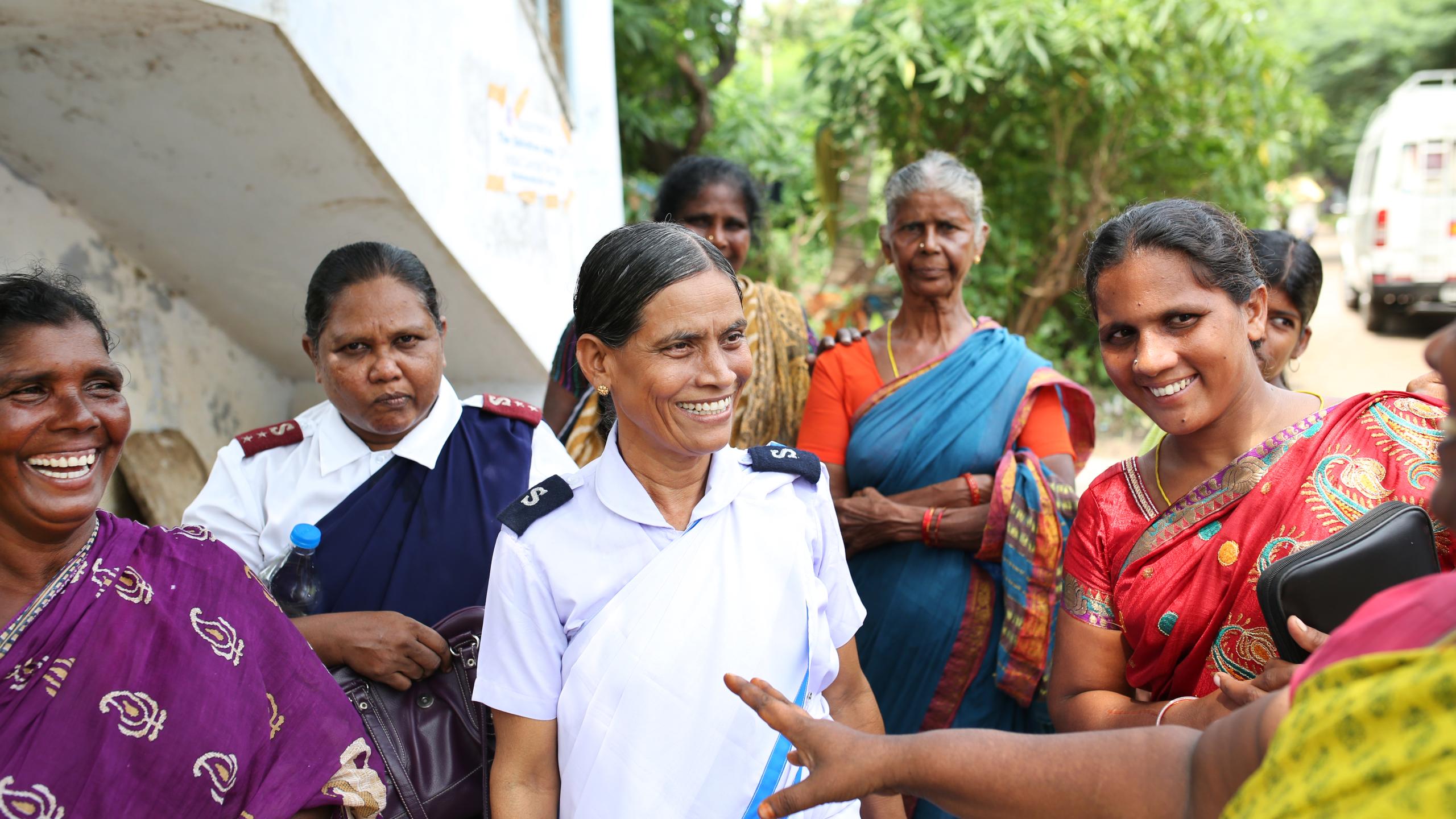 A group of women talking, two in Salvation Army uniform, others in traditional south Asian dress