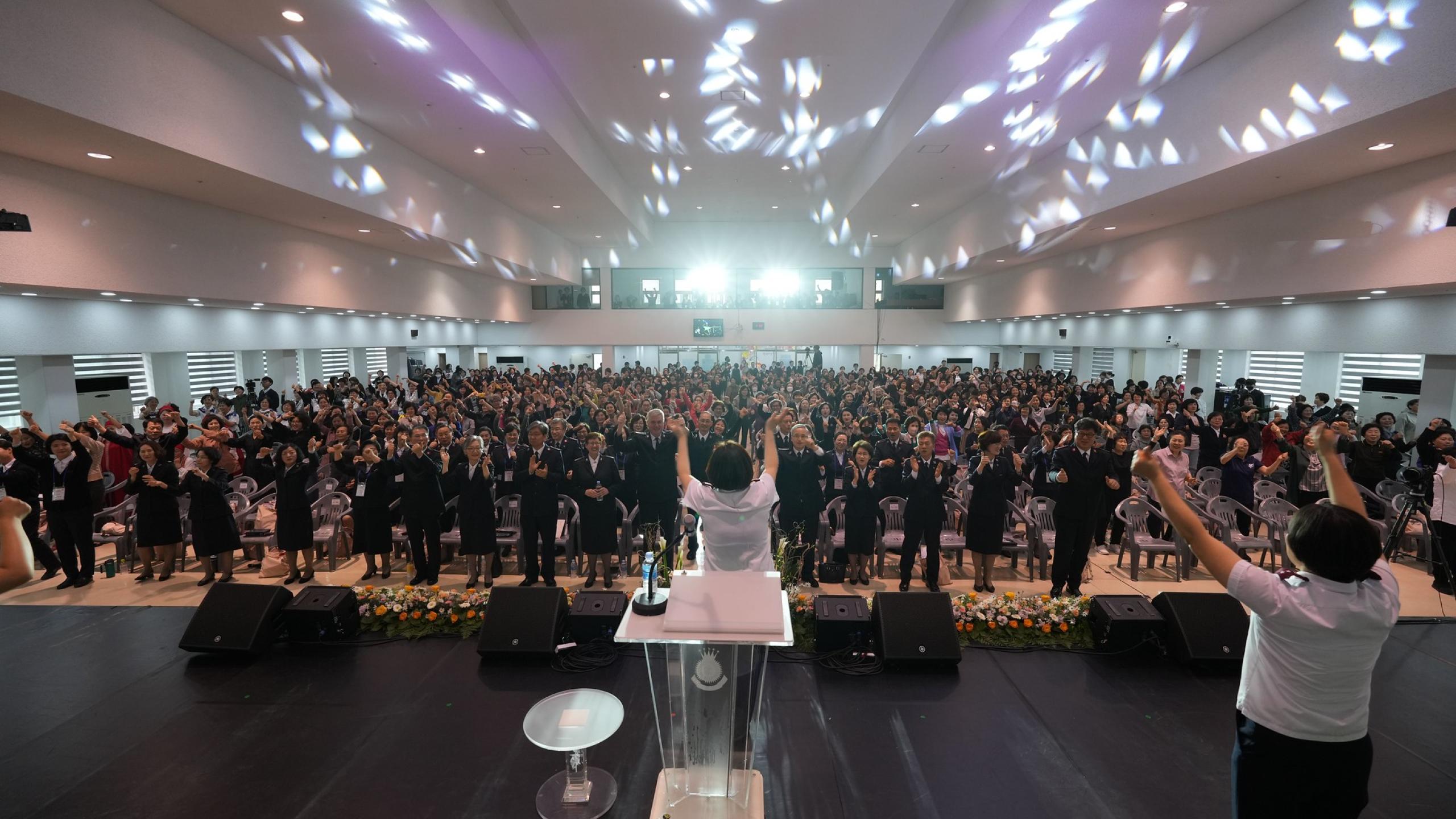 A crowd raise their hands in worship