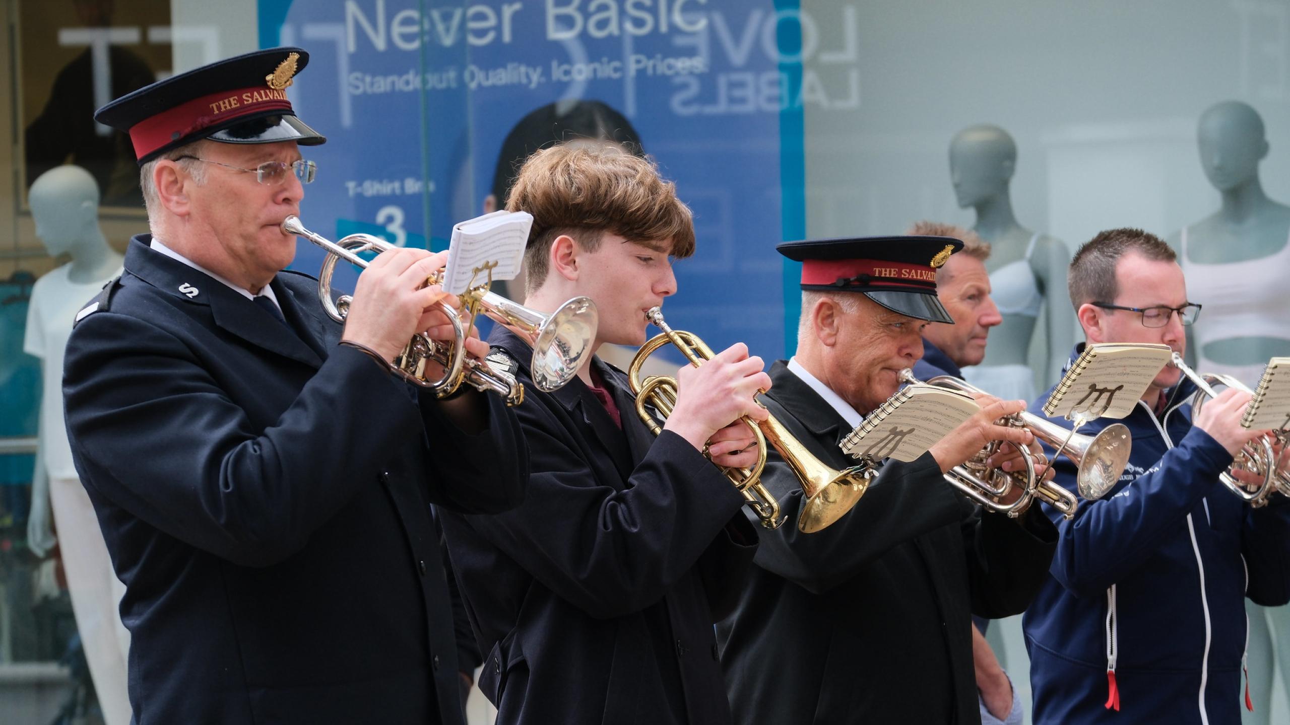 A Salvation Army brass band plays on the high street