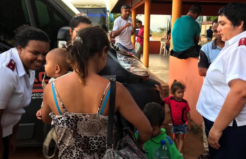 Salvation Army officers speak to a family in Brazil