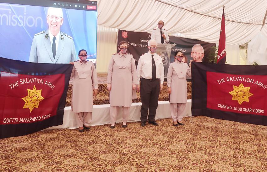 Salvation Army officers holding flags