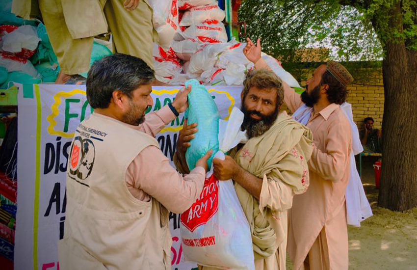 Volunteers unload supplies from a truck